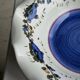 Small hand-painted earthenware salad bowl with garland of blue flowers, mark below