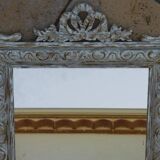 Chic and stylish antique mirror with carved wooden frame in whitewashed