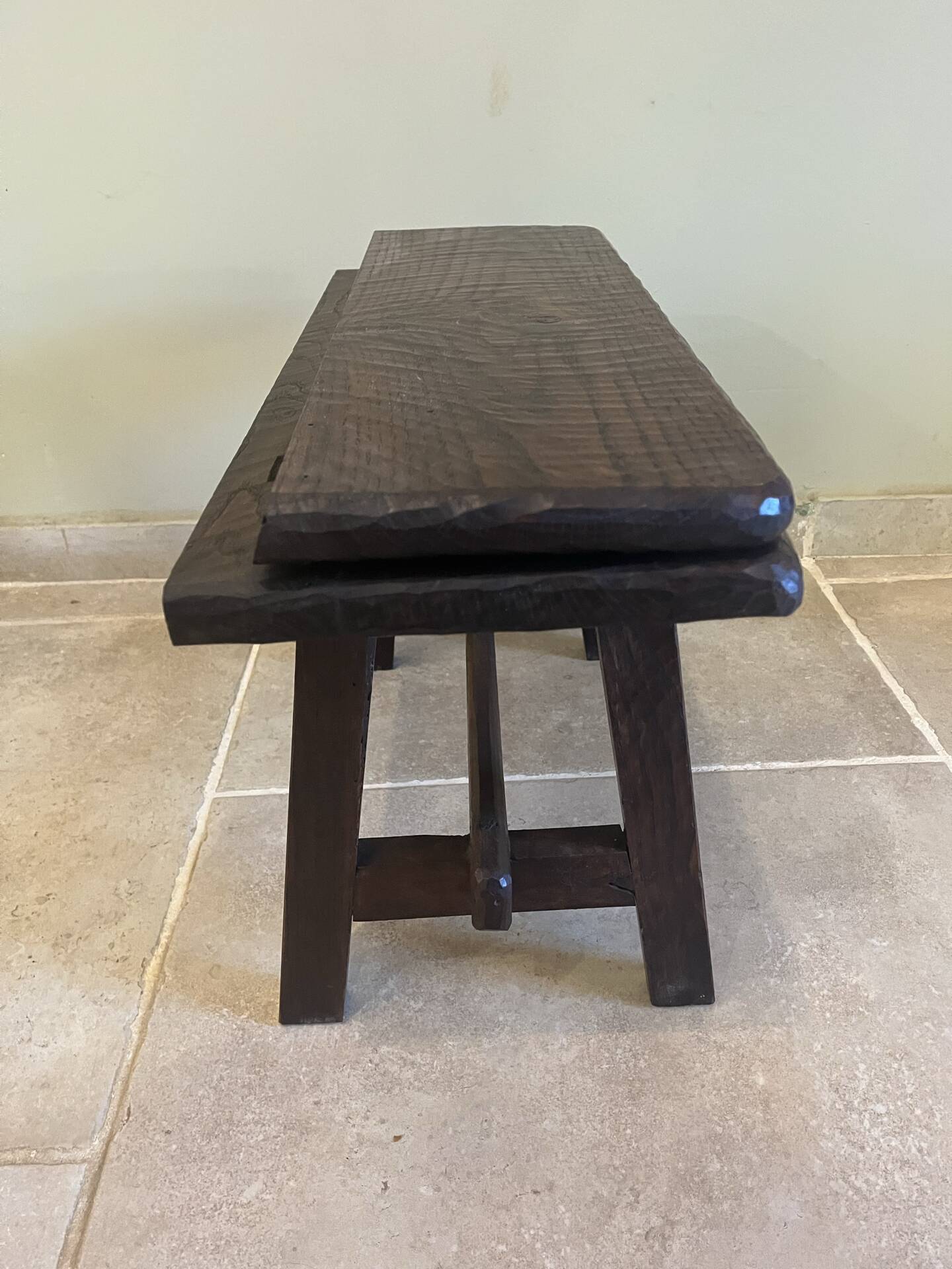 Small antique wooden bench with a folding backrest.