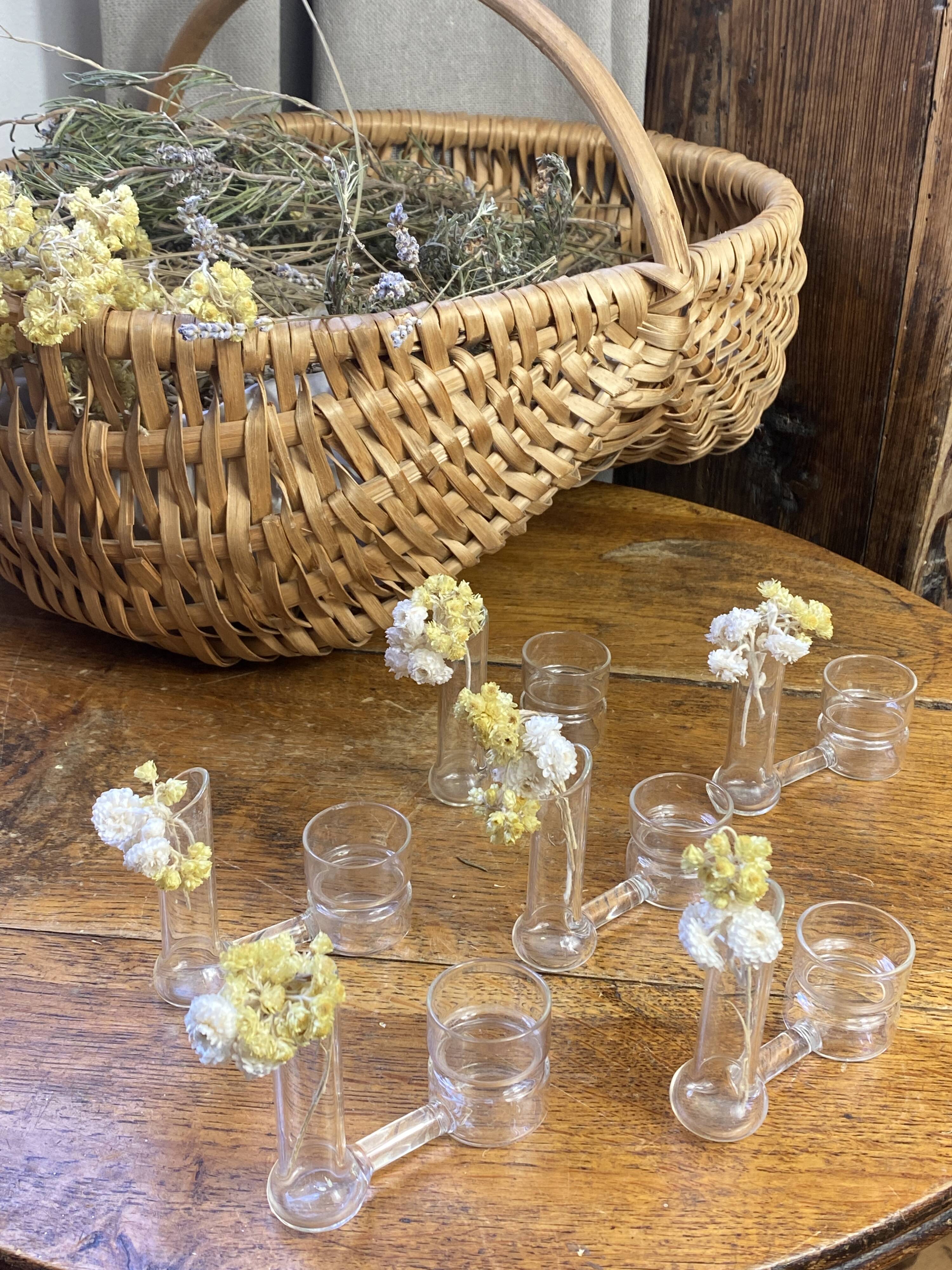 Knife rests, flower vases and candle holders in blown glass.