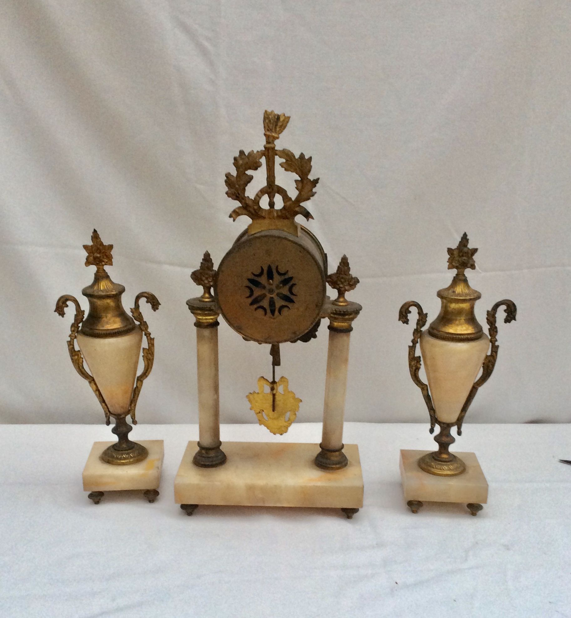 Clock fireplace trim and two vases in onyx and bronze style Louis XVI