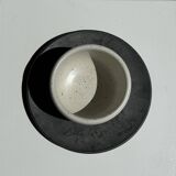 White Indonesian ceramic cup and gray saucer
