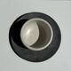 White Indonesian ceramic cup and gray saucer