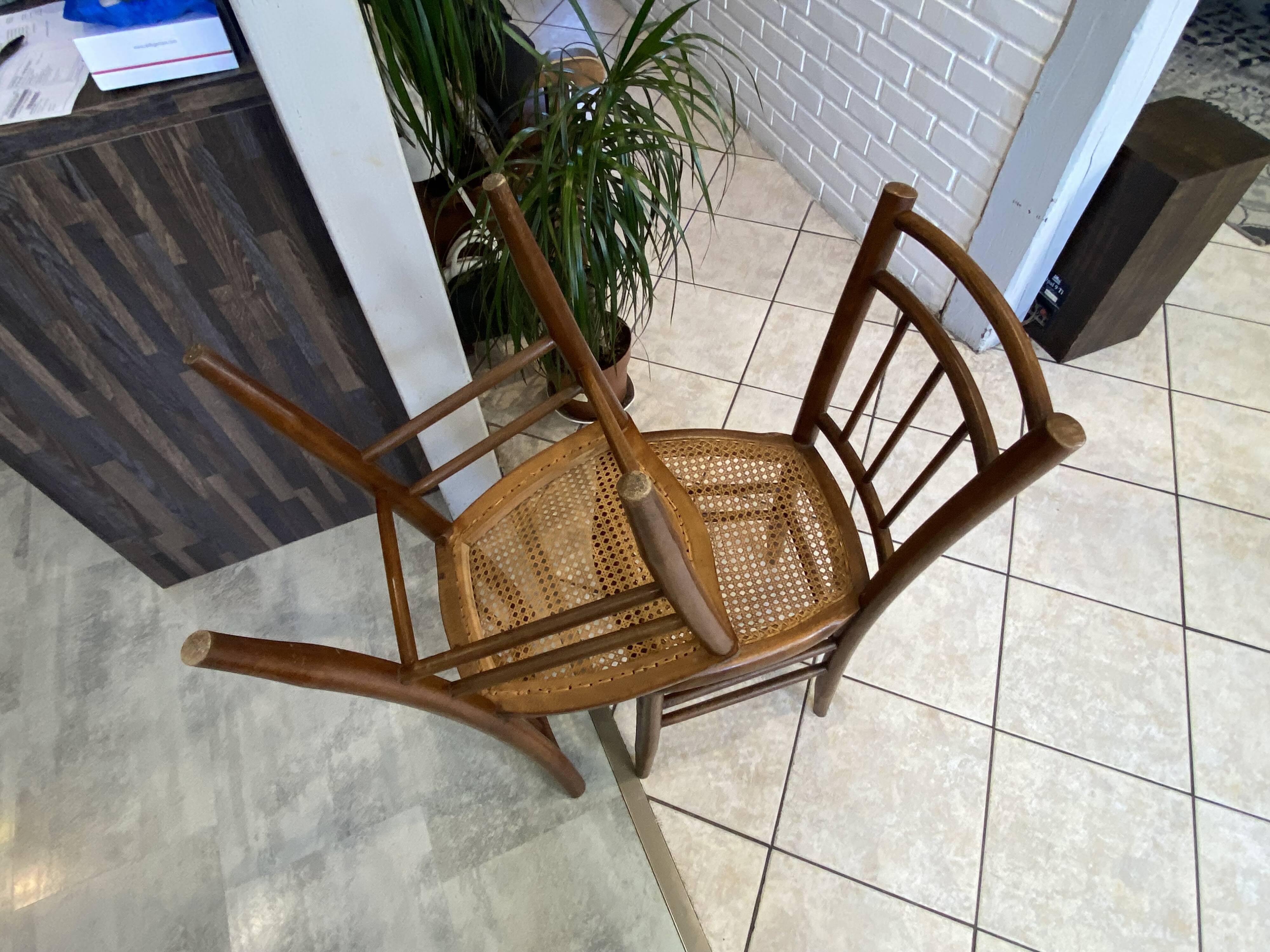 Pair of antique caned and wooden chairs from the 1900s.