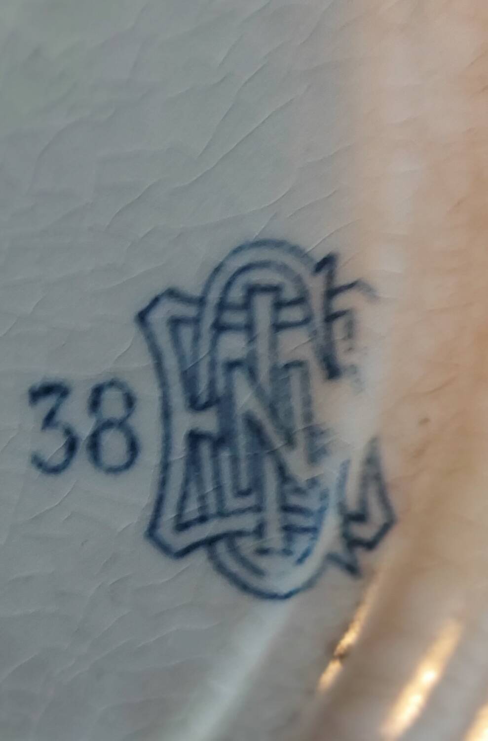 Two antique 19th-century plates, one flat and one deep, from Gien.