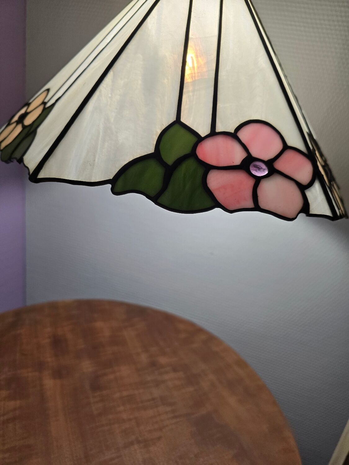 Tiffany-style stained glass lampshade with floral motifs.