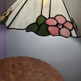 Tiffany-style stained glass lampshade with floral motifs.