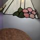 Tiffany-style stained glass lampshade with floral motifs.