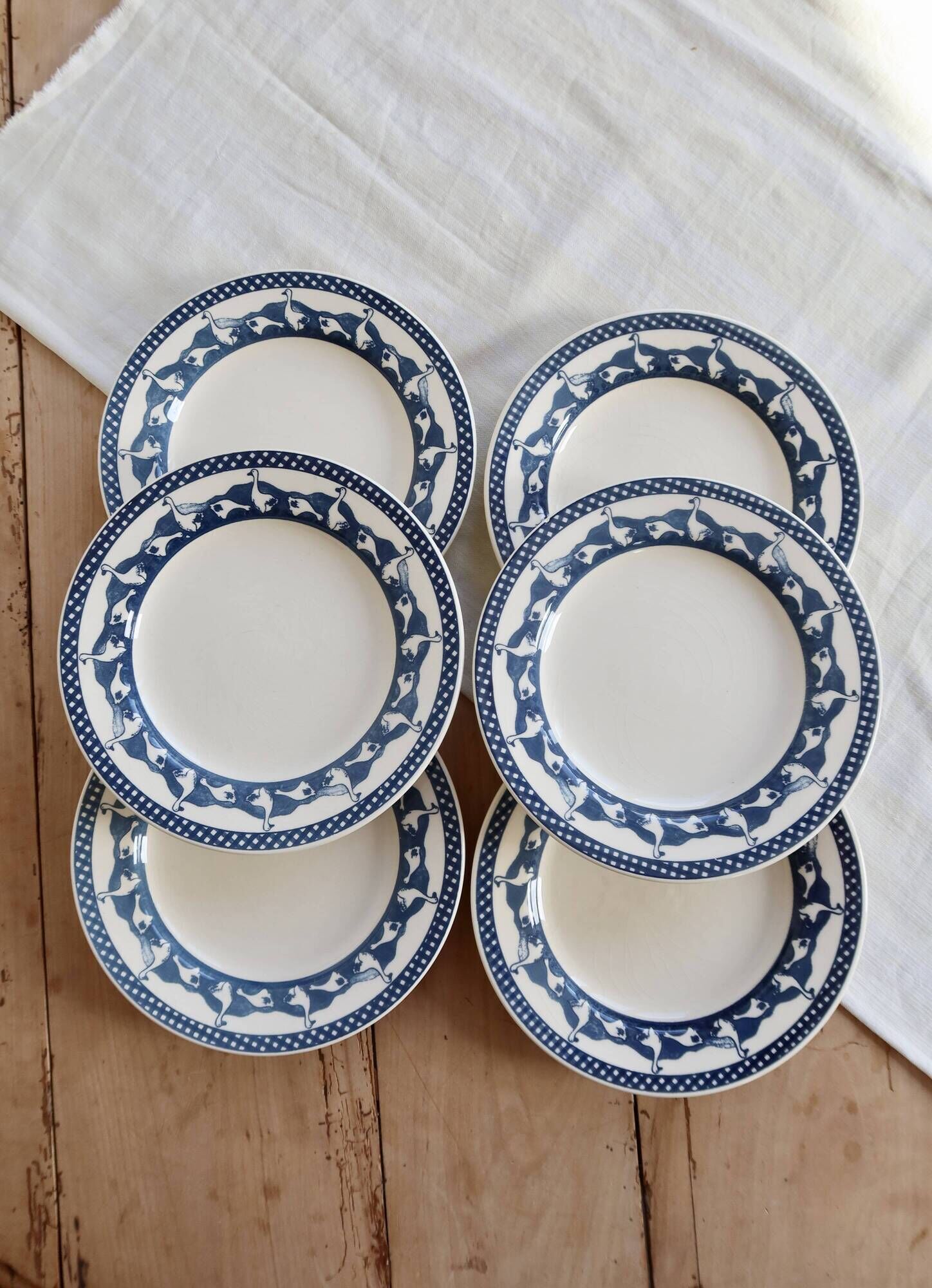 6 vintage flat plates with a blue and white goose pattern.