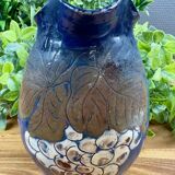 Blue ceramic pitcher with vintage artisan inscription decoration.