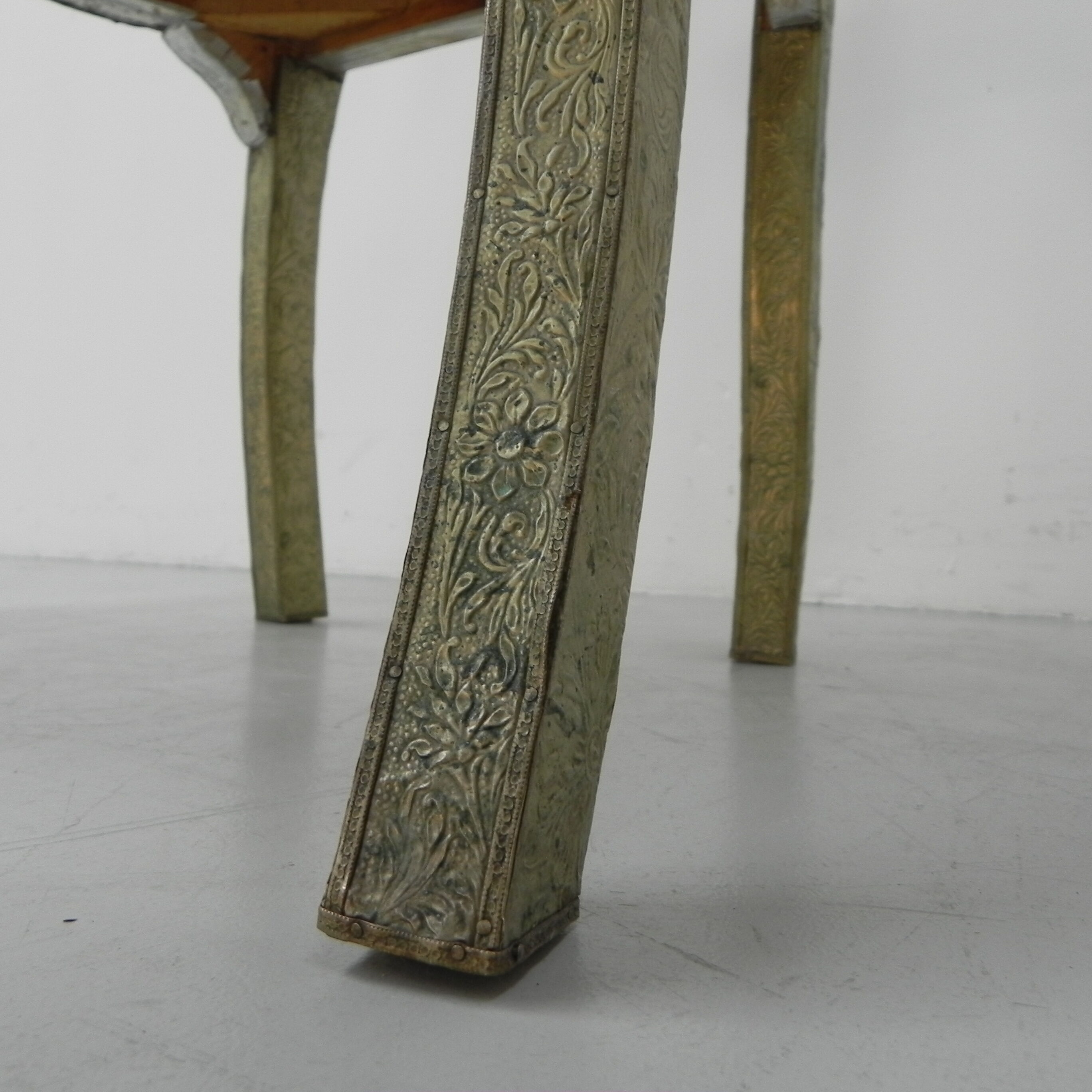 Dining chair upholstered with stamped tin