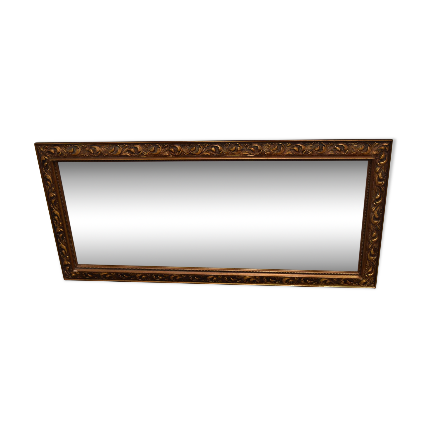 wall mirror in a decorative wooden frame.