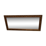 wall mirror in a decorative wooden frame.