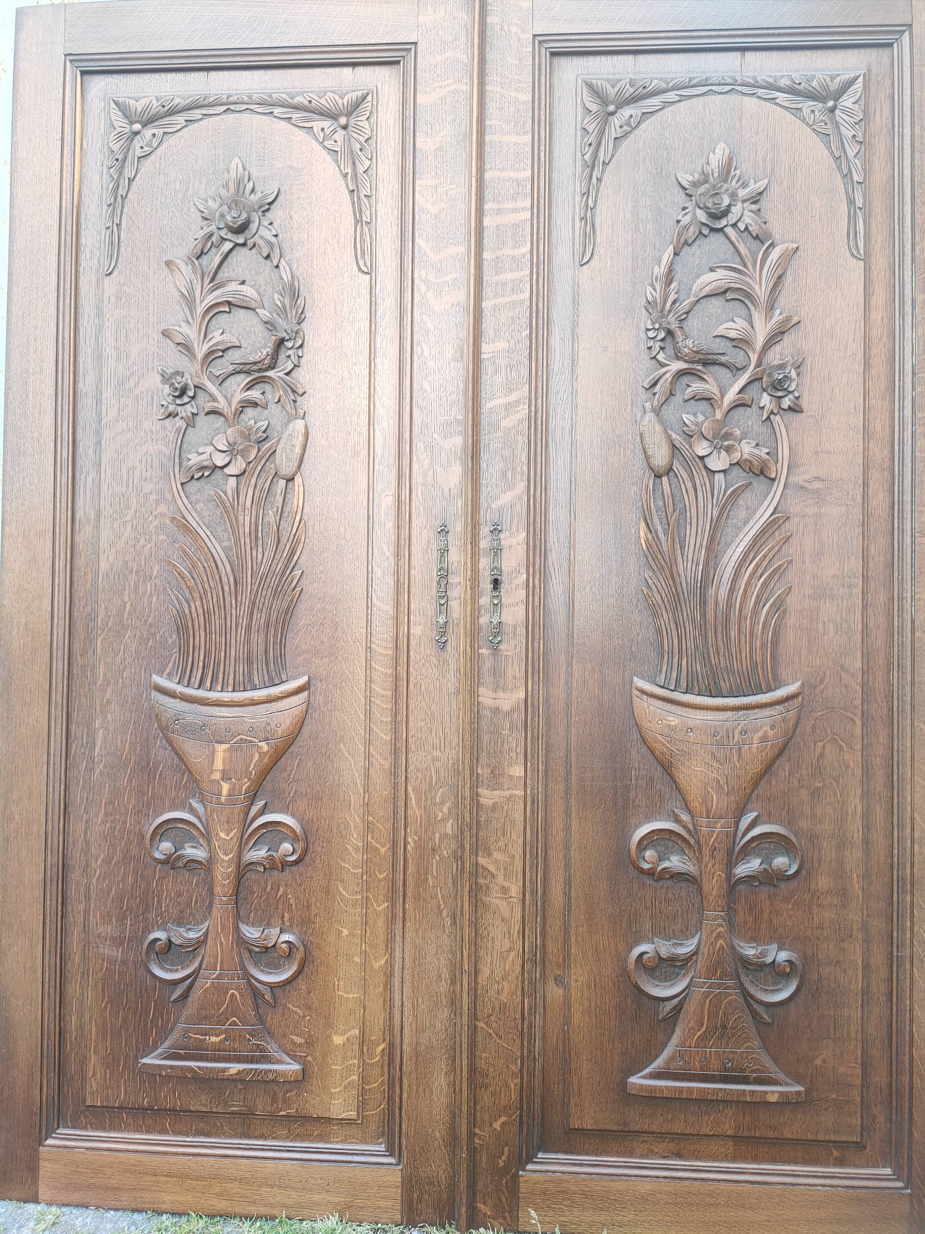 pair of antique solid oak cabinet doors with bird decor