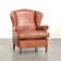 Fauteuil anglais à oreilles de couleur cognac clair en cuir de vache.