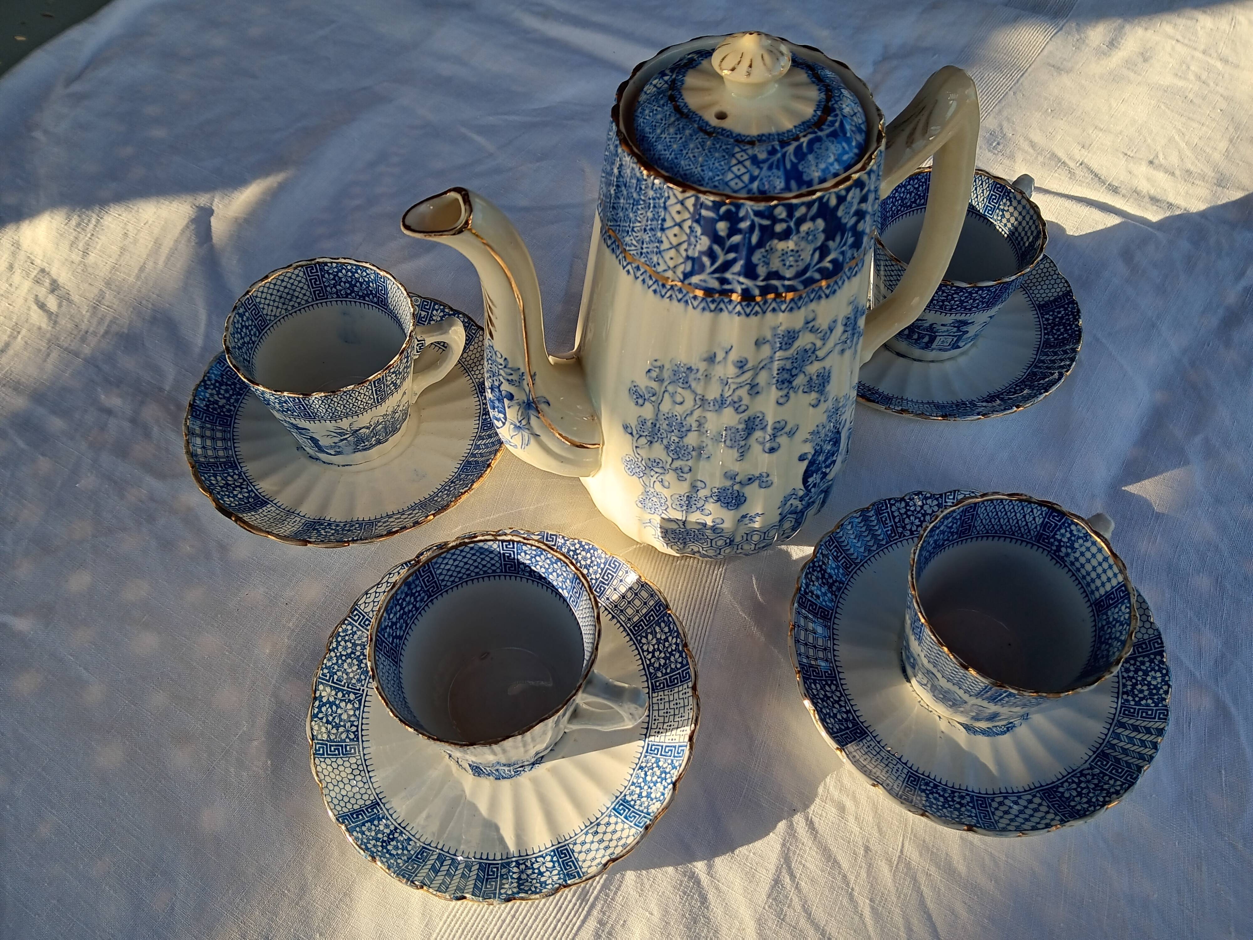 Old coffee service Lunéville with blue lace decoration.