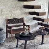 Small antique Indonesian bench in carved teak with plant and floral motifs.