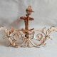 Wall lamp in antique cast iron with bird and scroll decorations.