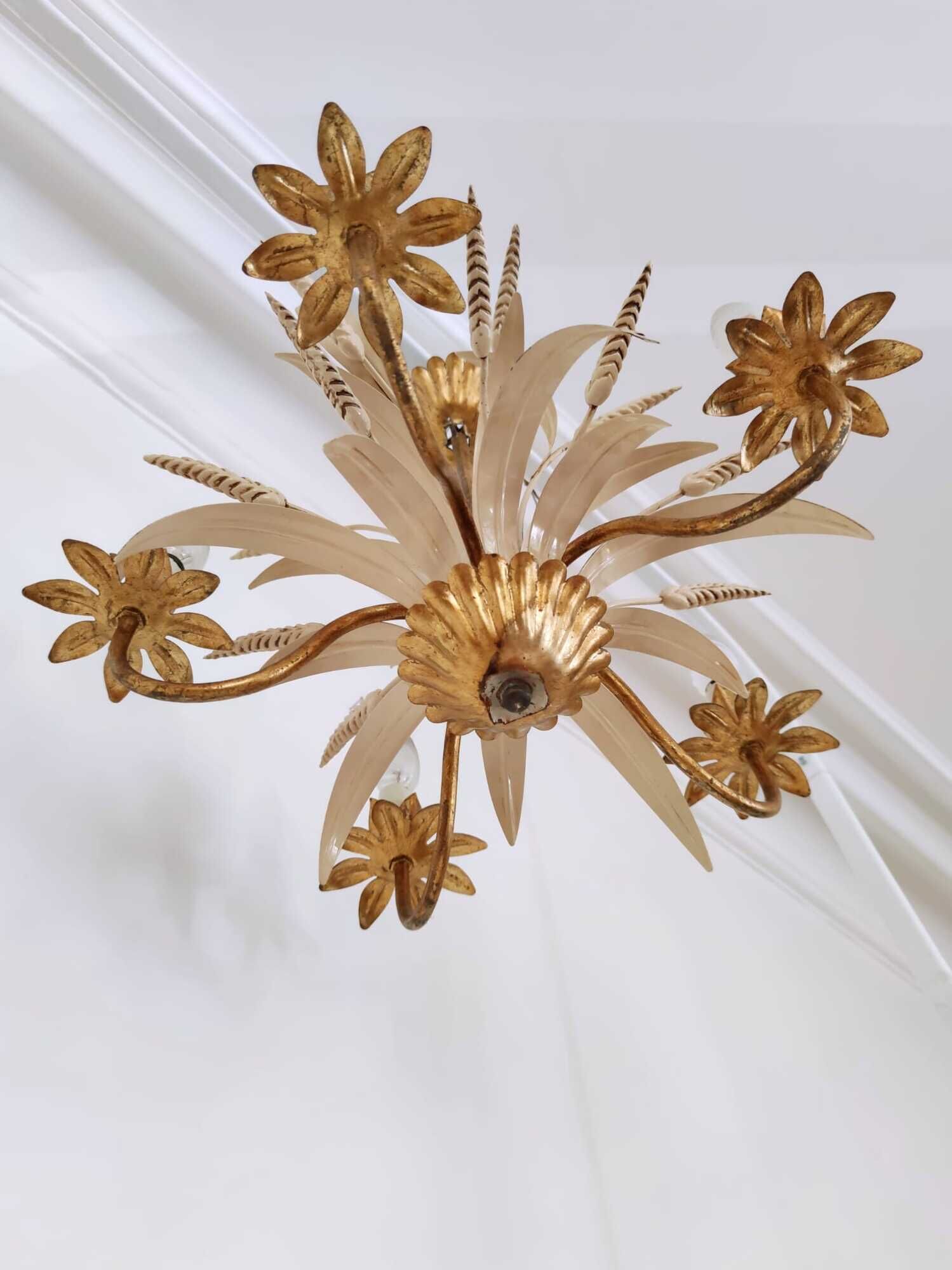 Vintage wrought iron chandelier decorated with golden and beige reeds