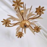 Vintage wrought iron chandelier decorated with golden and beige reeds