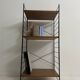 small vintage metal and teak string bookshelf