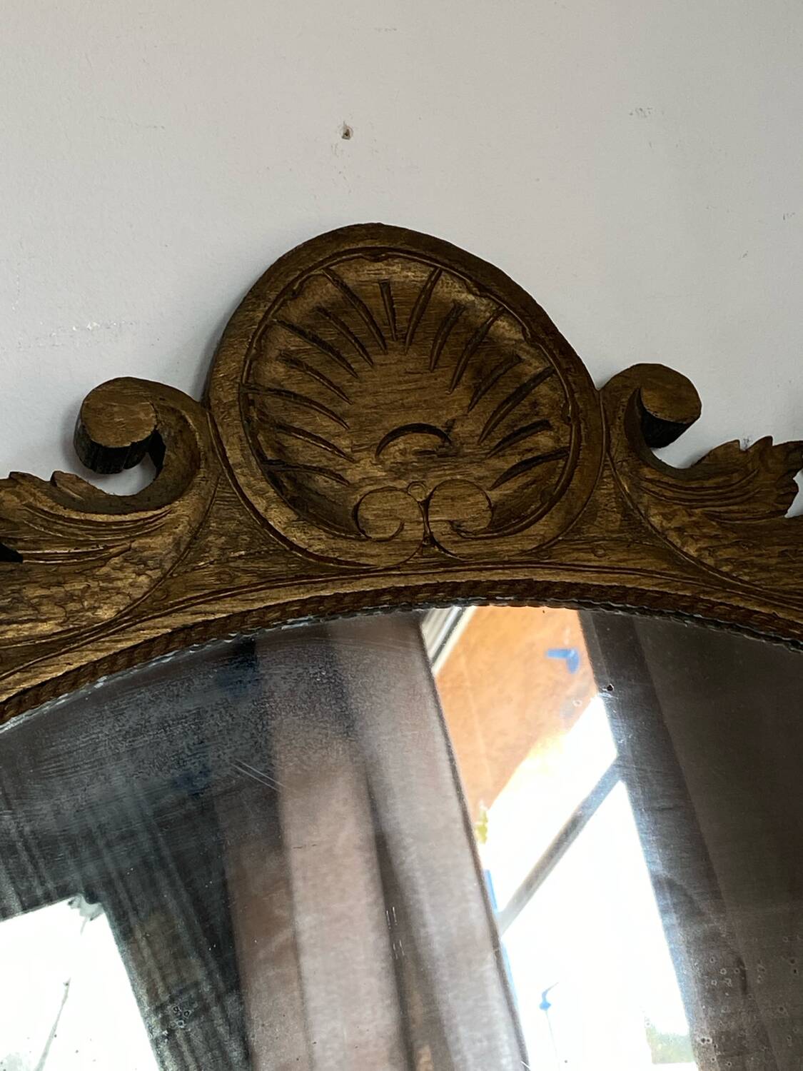 Antique wooden mirror with an unusual shape