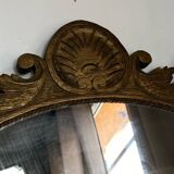 Antique wooden mirror with an unusual shape