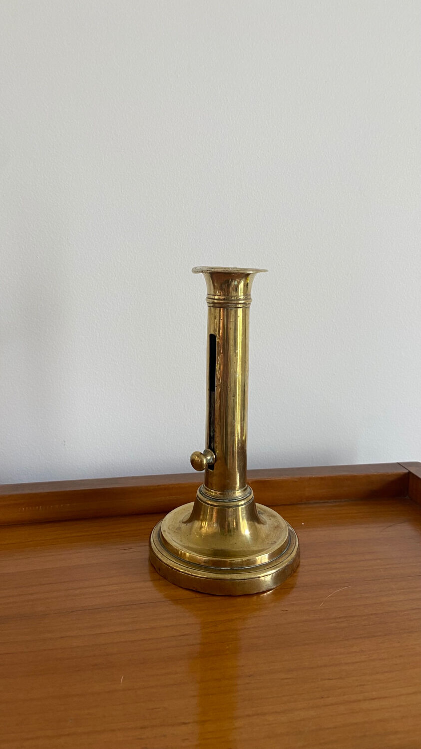 Old brass push candle holder