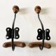 Pair of antique wooden and metal coat hooks