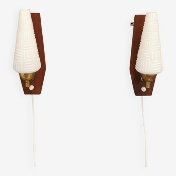 Danish wall lights from the 1970s, made of milky white glass shades, teak wood suspension and brass.