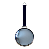 Vintage witch's eye curved mirror hangs velvet ribbon