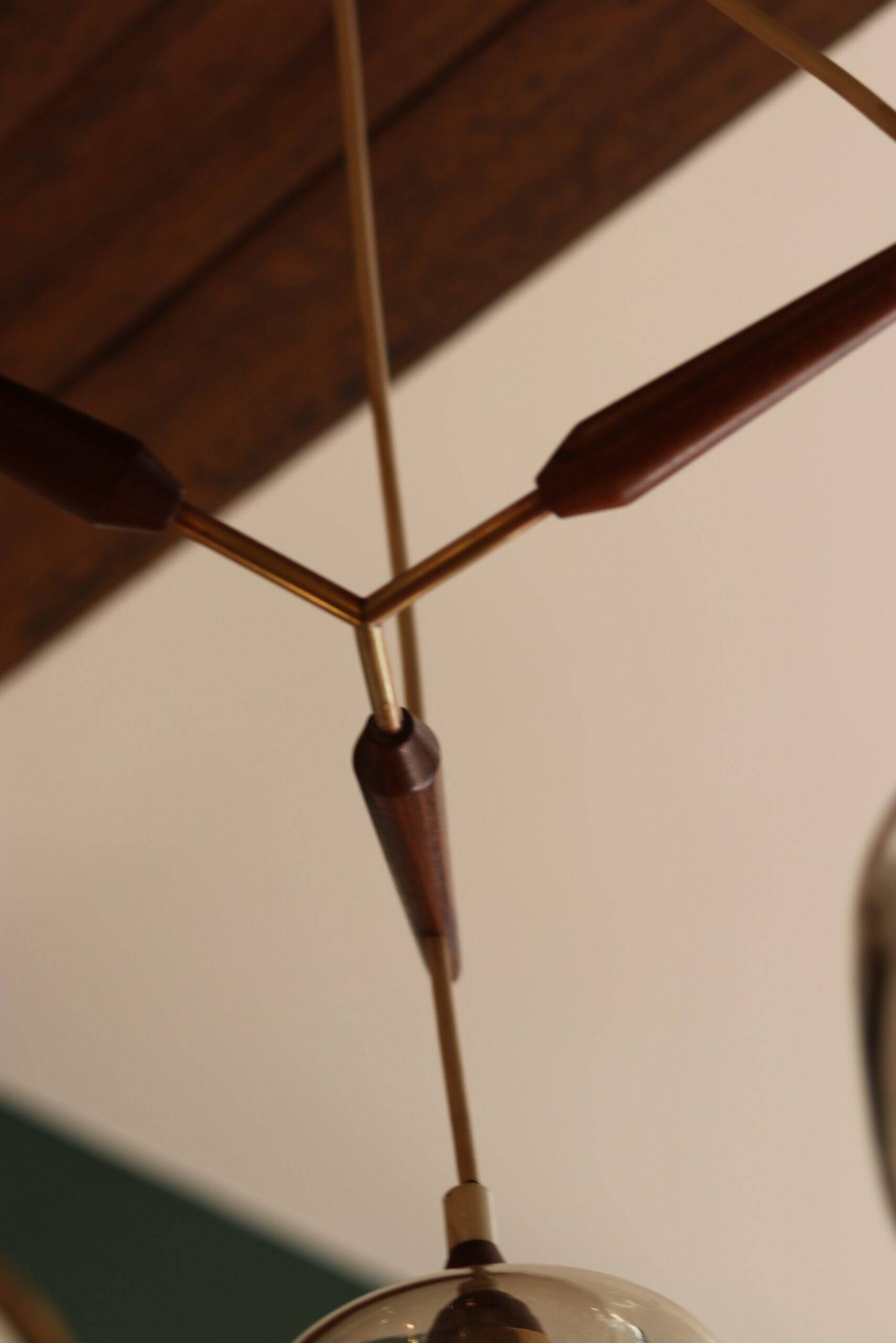 Scandinavian chandelier "Cascade" from the 1960s in brass, teak, and smoked glass.