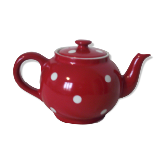 Old teapot in red earthenware with white polka dots