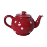 Old teapot in red earthenware with white polka dots