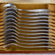 Art Deco oyster forks in punched silver metal, leatherette box
