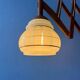 Vintage wall lamp with teak wood scissors and glass shade.