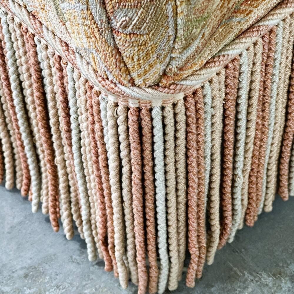 Pair of sculptural Hollywood Regency lounge chairs with original fringed upholstery