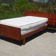 Vintage bed in teak with integrated bedside table.