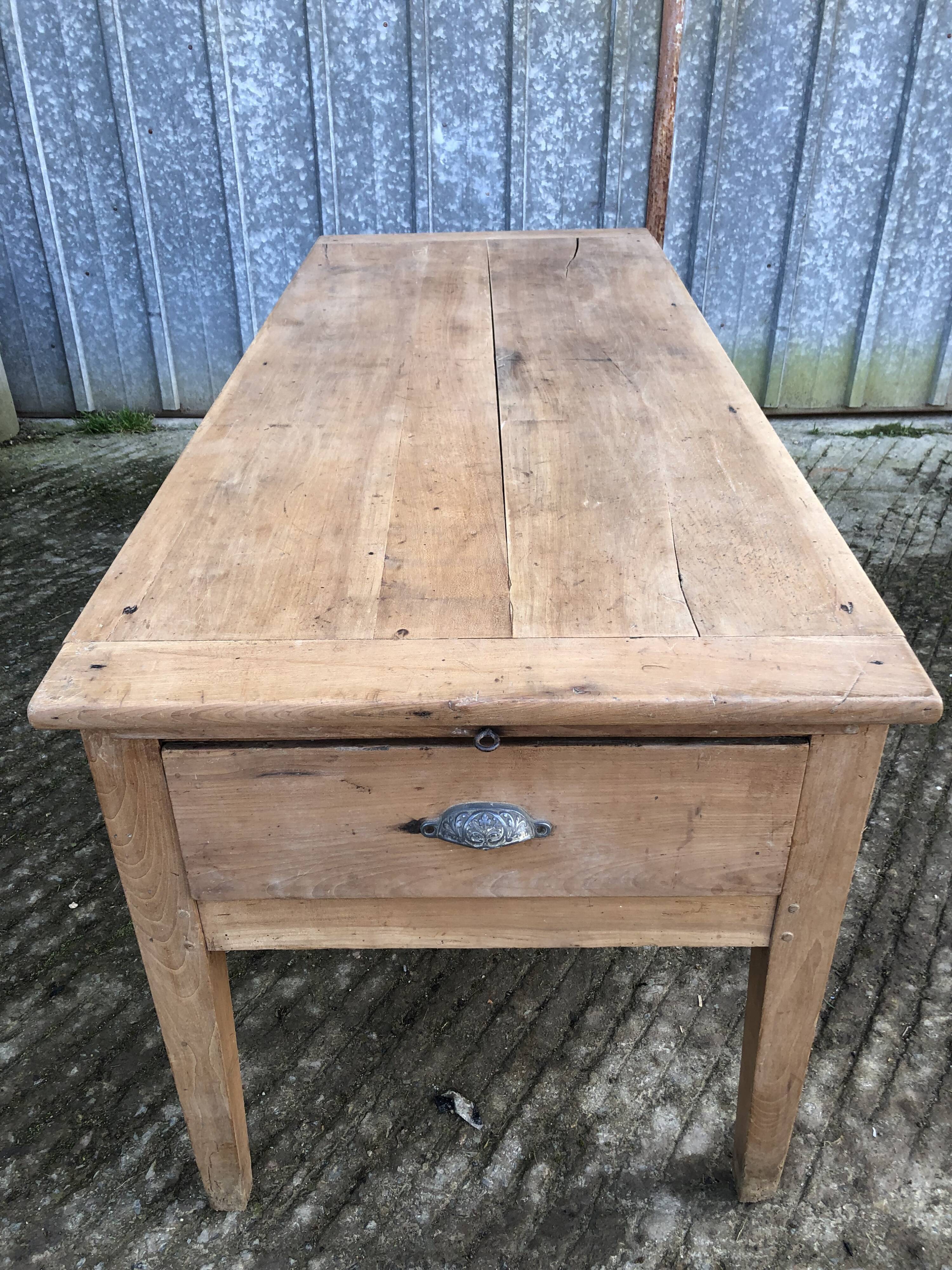 Antique solid cherry farmhouse table with 3 drawers and 1 pull out.