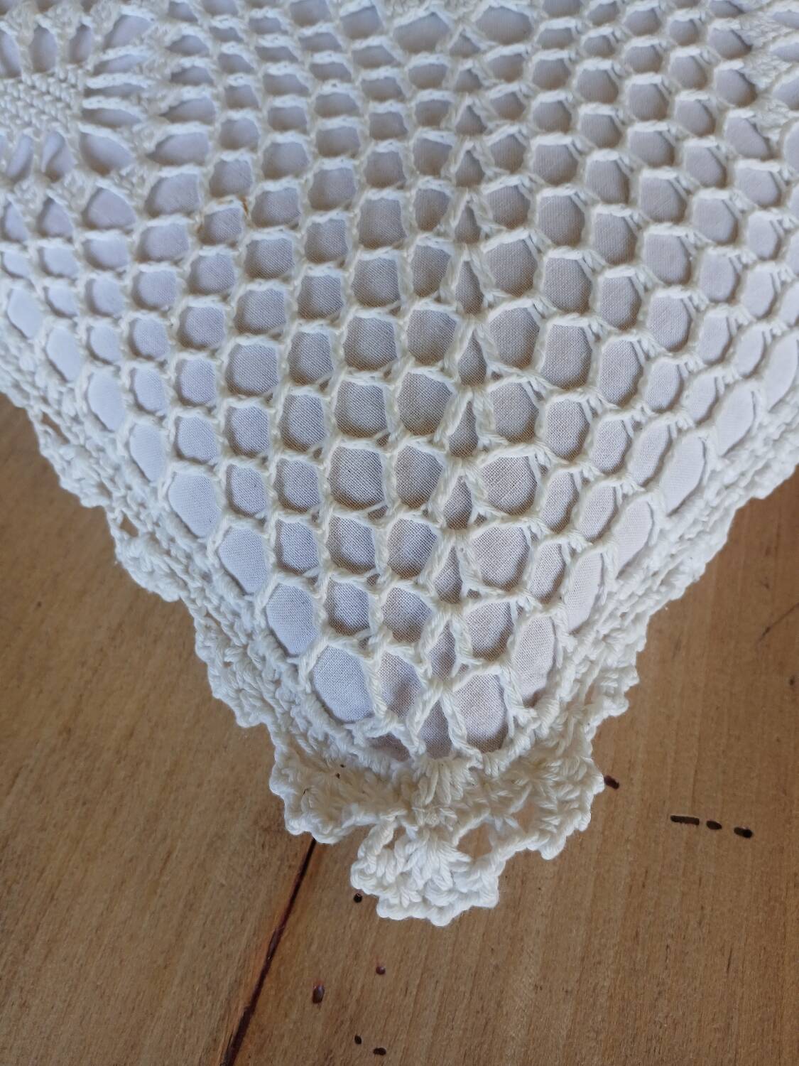 Cushion with white crochet cover