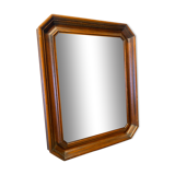 Beveled mirror in its wooden frame