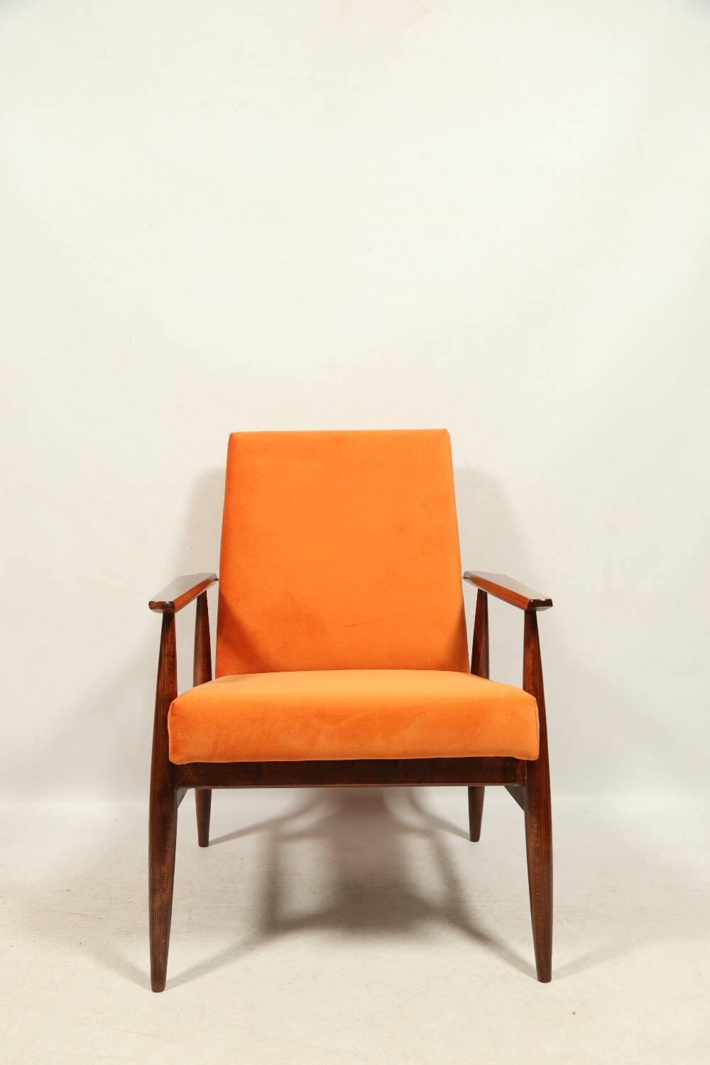 Modern armchair in orange papaya velvet with dark brown wood, 1970s Scandinavian style.