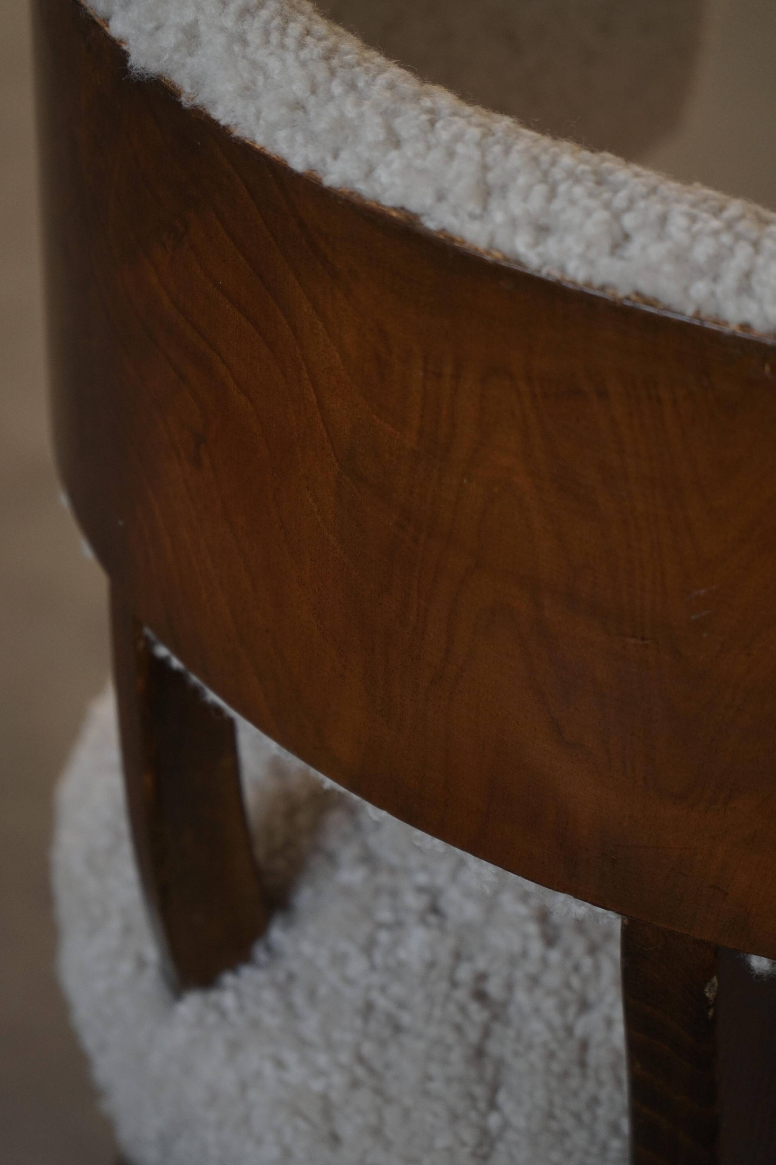 A modern Danish elegant low-back chair, reupholstered in lambswool, 1940s.
