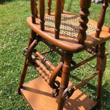 Old baby high chair in wood and canework