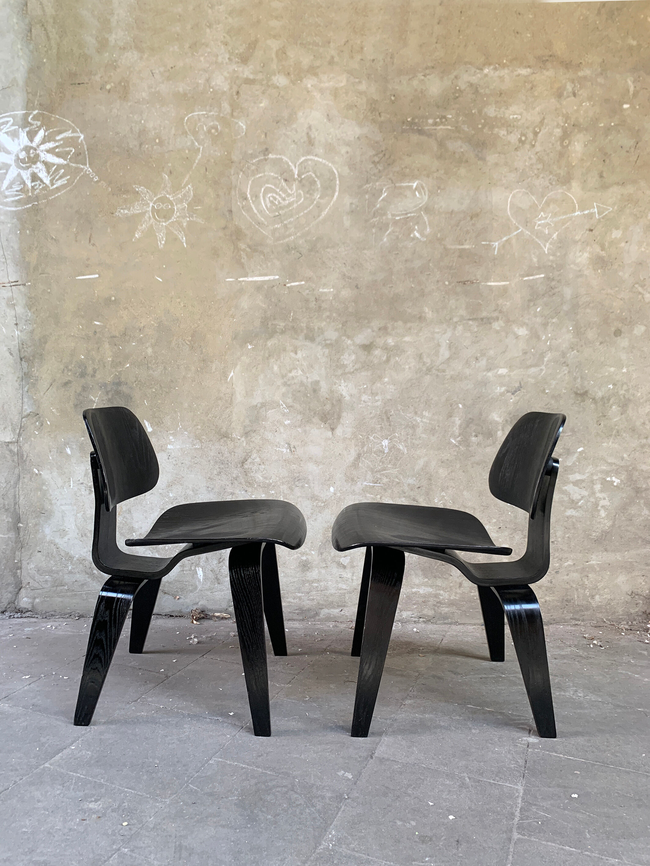 Pair of DCW chairs by Charles & Ray Eames in Black for Herman Miller 1950