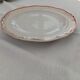 Set of 12 stylised white porcelain dinner plates, signed.