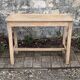 Art Deco farmhouse table made of raw wood.