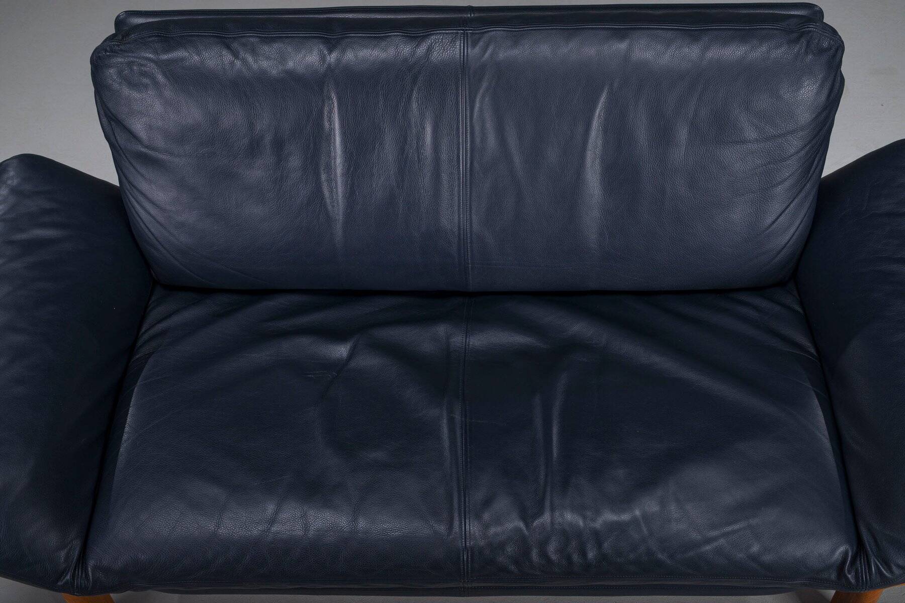 Danish teak and navy blue leather 2-seater sofa from Komfort, 1970s