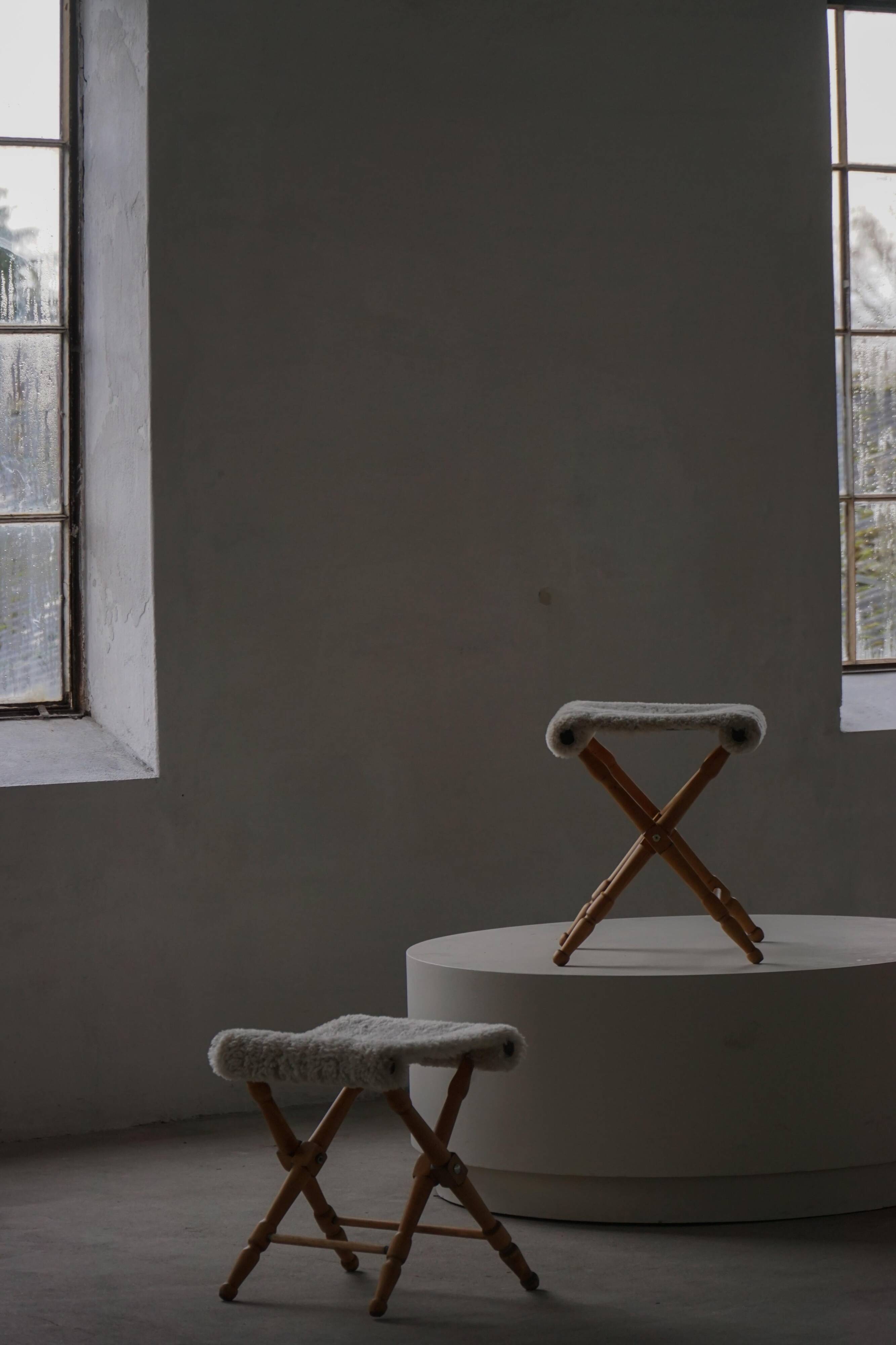 Pair of Danish mid-century folding stools with sheepskin upholstery, 1960.