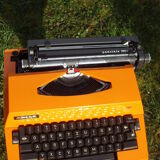 Electric writing machine adler orange and black with its suitcase